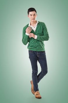 Handsome young Asian man with sweater, full length portrait isolated.