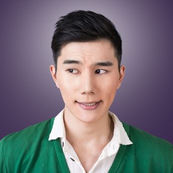 Funny facial expression, closeup Asian young man.