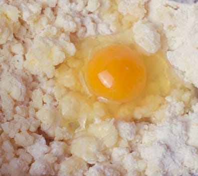 Dough with eggs and spoon in a bowl