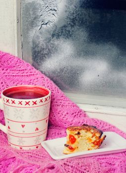 cup of tea on a windowsill near the winter window