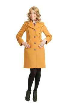 The girl in a yellow autumn coat on a white background