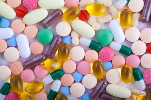 An assortment of pills, tablets and capsules on white background