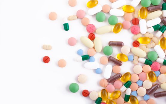 An assortment of pills, tablets and capsules on white background