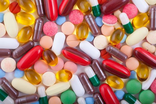 An assortment of pills, tablets and capsules on white background