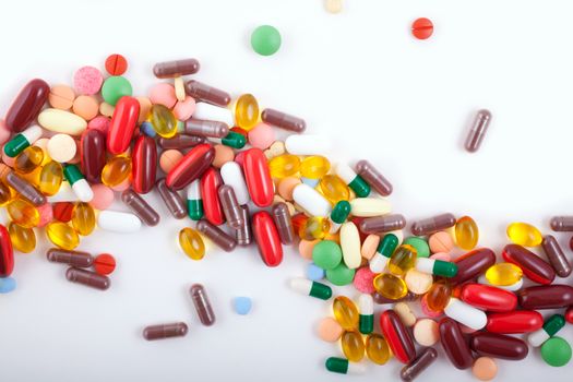 An assortment of pills, tablets and capsules on white background