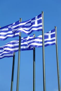 National Greek flags waving in wind against clear blue sky