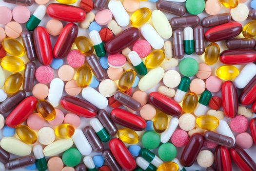 An assortment of pills, tablets and capsules on white background