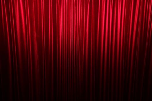 Large red stage curtain with light and shadow