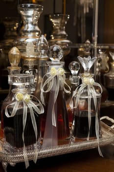 Decorated wedding bottles of homemade drink (cognac or brandy)