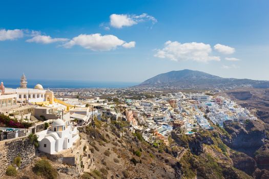 Cityscape of Fira, dramatically located on the edge of the caldera cliff on the island of Thira known as Santorini, Greece. Panorama shot.
