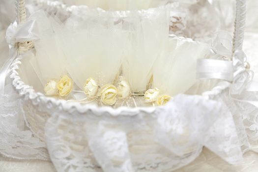 Elegant Wedding Favors decorated with artificial flowers in basket