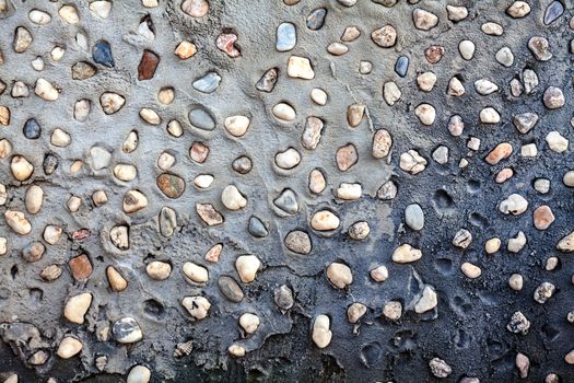 Small pebbles set in concrete wall texture