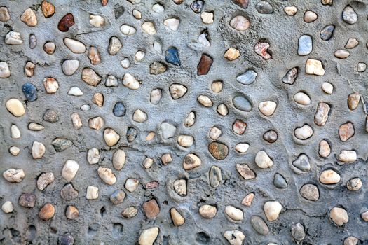 Small pebbles set in concrete wall texture