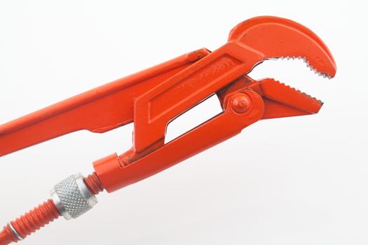 Orange pipe wrench on white background