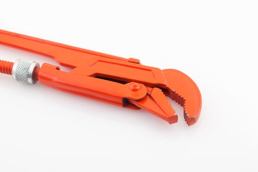 Orange pipe wrench on white background