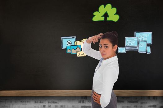 Worried businesswoman against blackboard on wall with business technology doodle