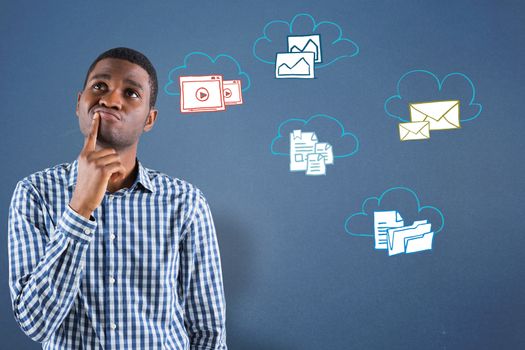 Young businessman thinking against blue background with technology doodles