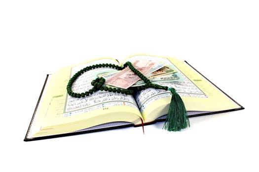 whipped Quran with Afghani before light background