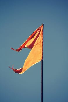Orange Hindu temple flag in the breeze