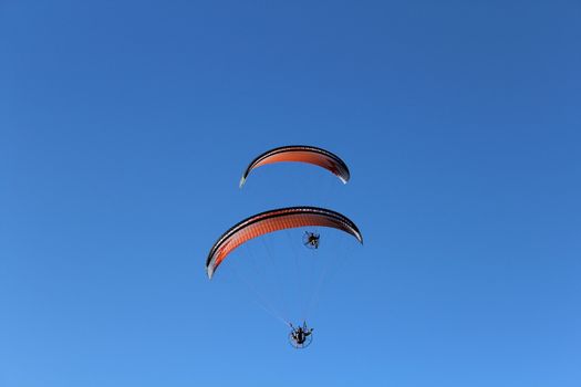 Some pilots, paragliders, make the spectacular perform