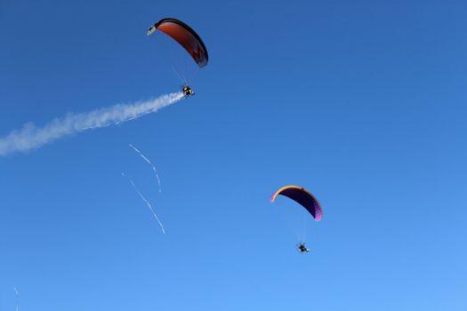 Some pilots, paragliders, make the spectacular perform