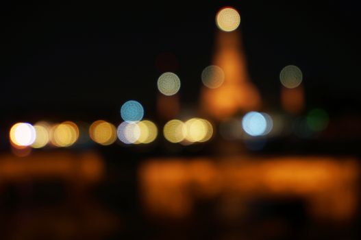 Temple of Thailand at night and bokeh of light from riverside.                   