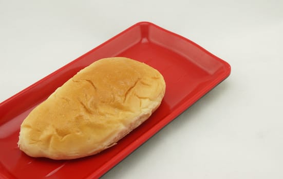 Thai custard bread on red plate, is sweet ,delicious and appitizing.                        