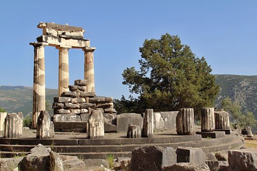 Photo shows old Delphi temple in the middle of the woods.