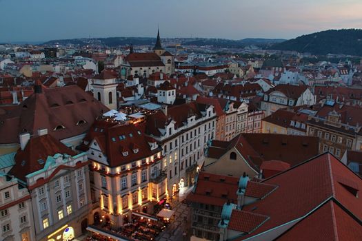 Photo shows details of Prague red roofs and old houses.