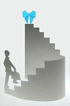 Businessman stepping up a staircase towards a Victory