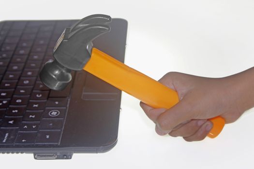 Hammer in Human Hand hitting a Laptop