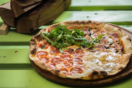 Delicious italian pizza served on wooden table. selective focus