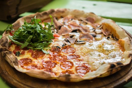 Delicious italian pizza served on wooden table. selective focus