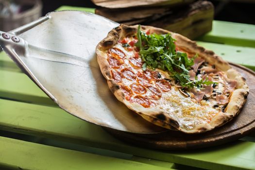 Delicious italian pizza served on wooden table. selective focus