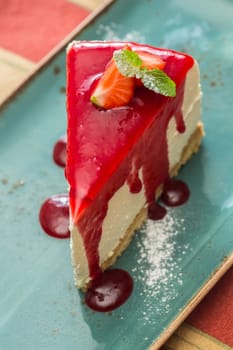 Dessert - Cheesecake with Berries Sauce and Green Mint. selective Focus