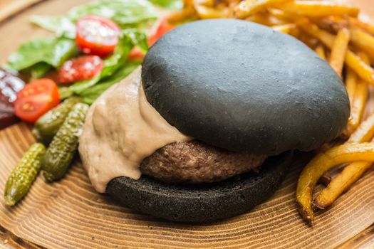 Delicious burger with beef, tomato, lettuce and fries. selective focus