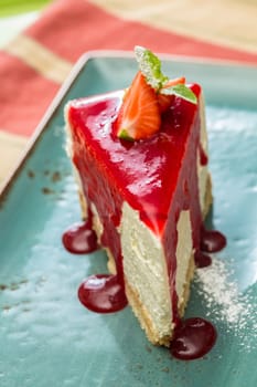 Dessert - Cheesecake with Berries Sauce and Green Mint. selective Focus