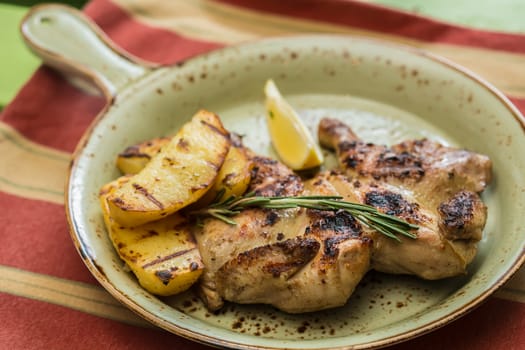 Grilled Chicken Plate in a restaurant. selective Focus