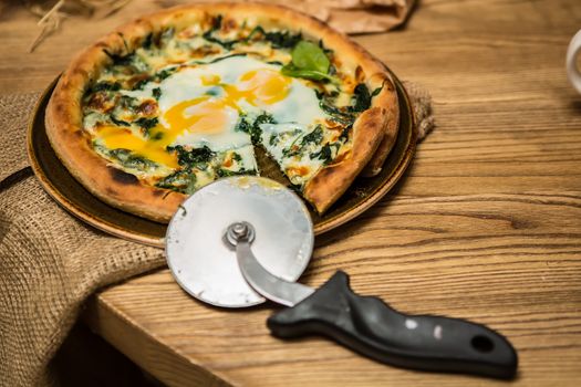 Margarita pizza with arugula and egg for breakfast, selective focus