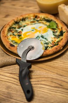 Margarita pizza with arugula and egg for breakfast, selective focus