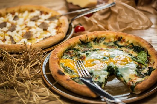 Margarita pizza with arugula and egg for breakfast, selective focus