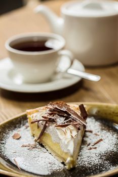 Cheesecake with Chocolate, baked to perfection. On plate with terracotta background. 