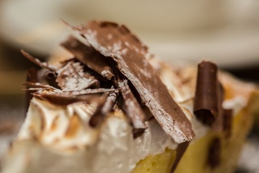 Cheesecake with Chocolate, baked to perfection. On plate with terracotta background. 