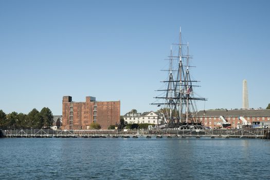 Boston Harbor, and the USS Constitution moored. The ship is a three masted wooden hulled ship, the oldest warship still operating in the world. It was named by George Washington in 1797.