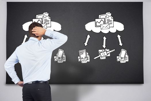 Thinking businessman scratching head against black chalkboard with business technology doodle