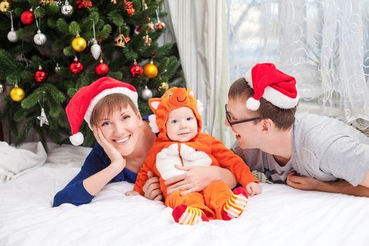 Young family with baby boy dressed in little fox costume