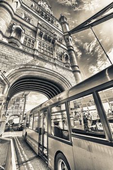 Double Decker bus crossing crowded Tower Bridge - London.