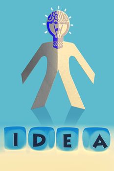 word Idea on cubes in front of paper man