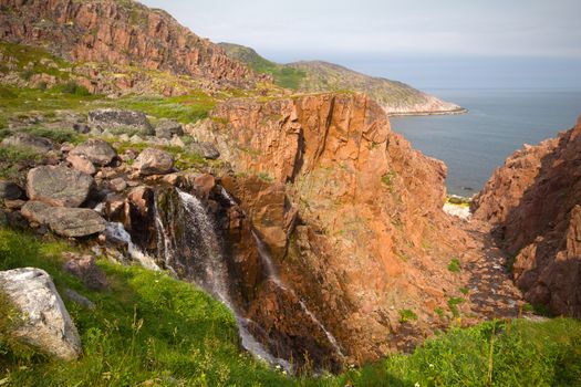 waterfalls behind a polar circle in the summer