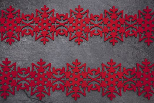 Christmas background with snowflakes. Christmas card with red snowflakes against gray background.